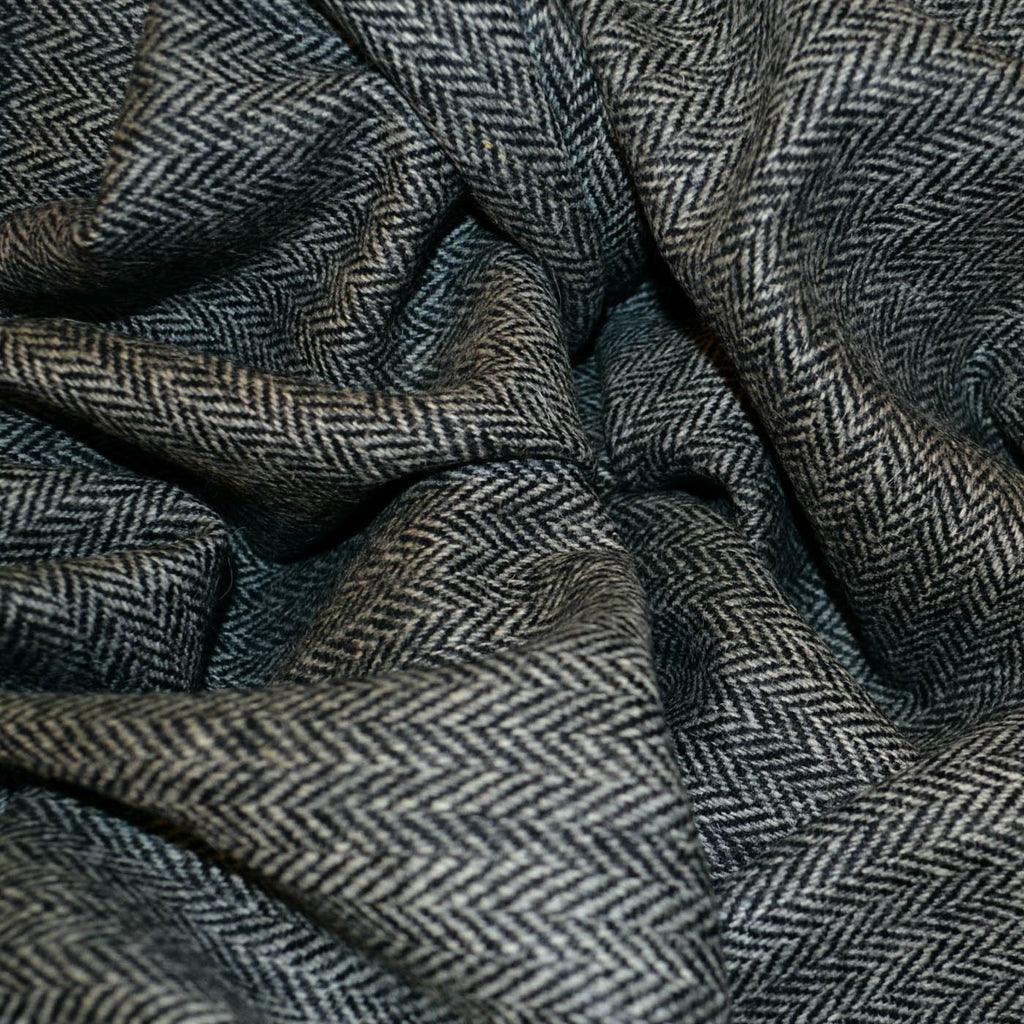 Harris tweed fabric, handwoven from 100% wool, featuring a distinctive, textured pattern and vibrant colors. Known for its durability and warmth, it's ideal for creating classic, high-quality jackets and coats.