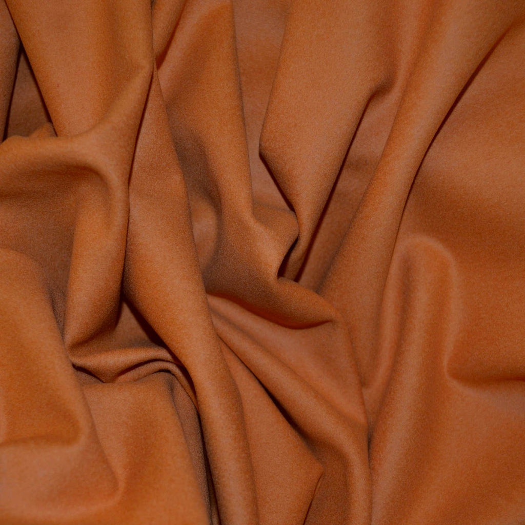 Close-up of moleskin fabric showcasing its soft, velvety texture in a rich, muted color. Ideal for both stylish apparel and durable upholstery projects.