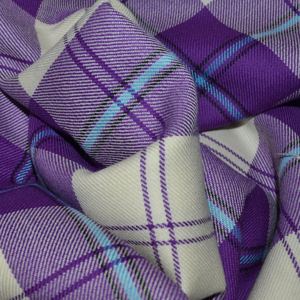 Lightweight tartan fabric from Yorkshire Fabric, featuring a classic plaid pattern in vibrant colors, ideal for creating stylish garments like skirts and kilts with a comfortable, breathable feel.