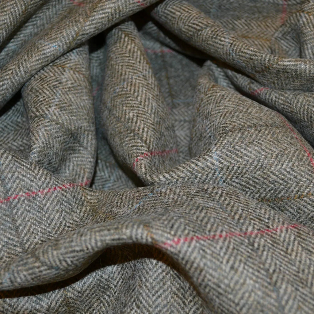 Close-up of Holland & Sherry tweed fabric showcasing its luxurious texture and classic pattern in rich, sophisticated colors. Ideal for high-end tailored suits, jackets, and elegant home decor.