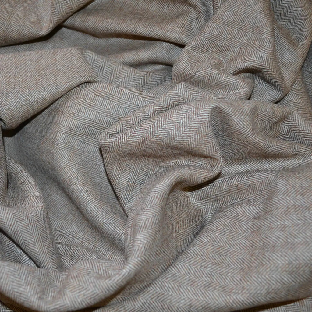 Close-up of soft, luxurious cashmere fabric showcasing its smooth texture and elegant sheen.