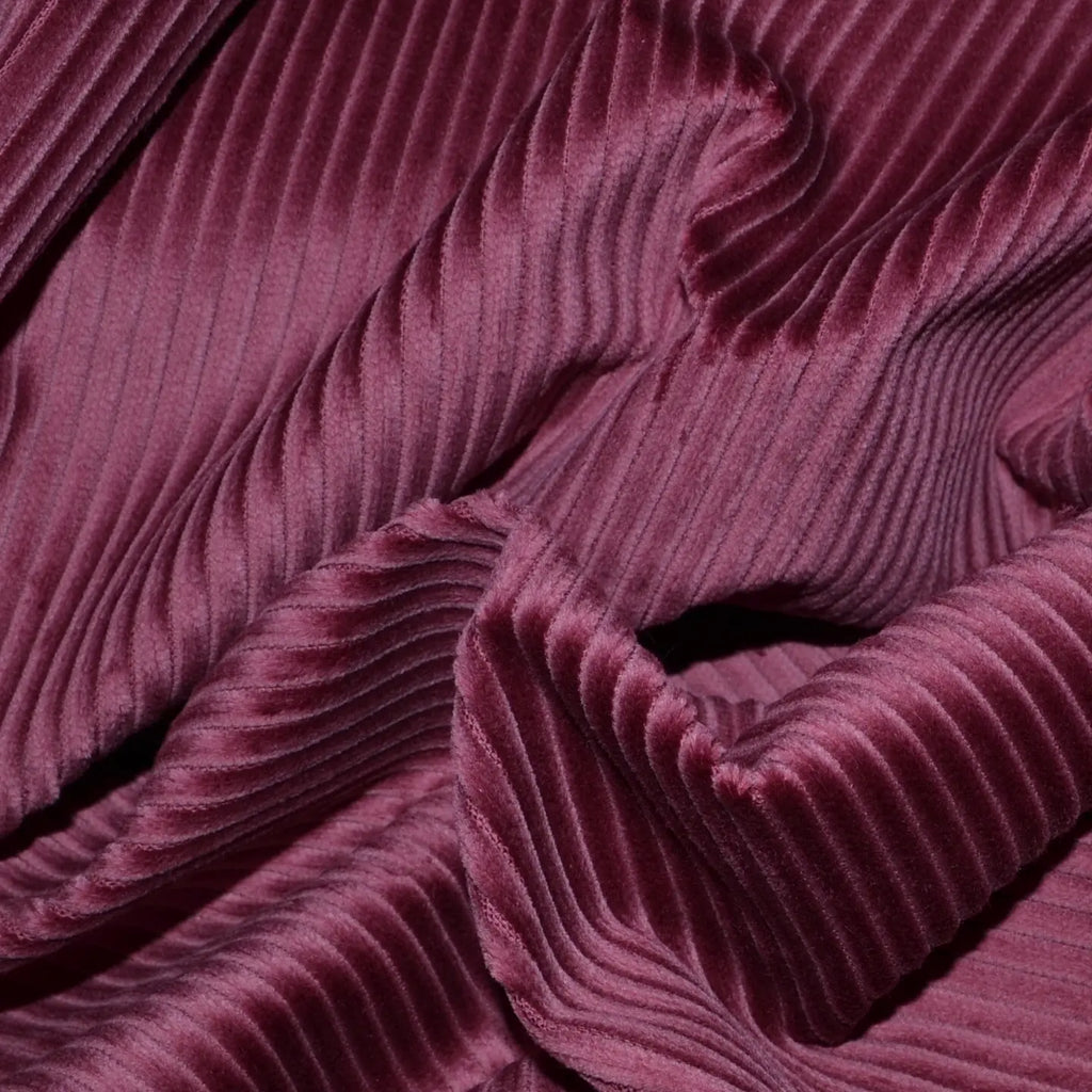 Close-up of 8 Wale corduroy fabric showing its distinctive ribbed texture in a rich, deep color, ideal for durable apparel and stylish upholstery projects